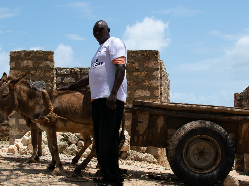 Resident of Manda, Justus Maniki with his donkey and cart during World animal day