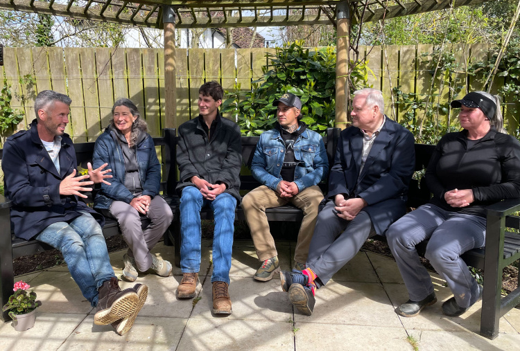 Oscar's Place team sitting in The Donkey Sanctuary gardens talking.