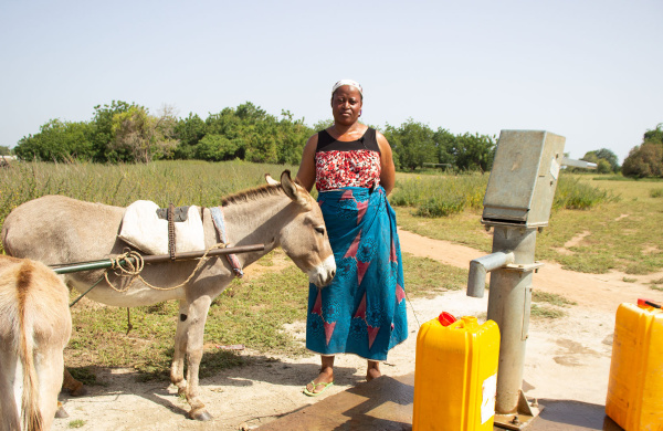 Mariama Braiamah at the borehole with donkeys