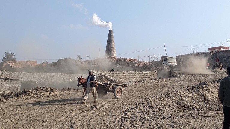 Cart equine with handler returning from the kiln.