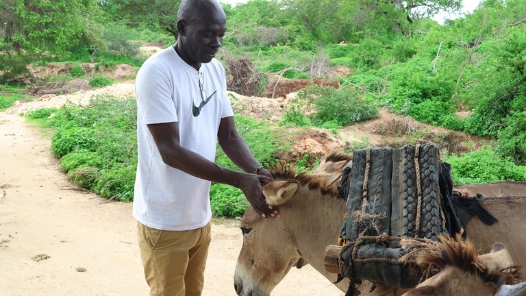 Benard Owuor with donkey near the quarry on Mandu Island