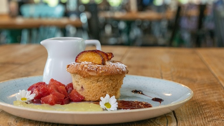 Damson and apple cake with vanilla custard and plum compote.