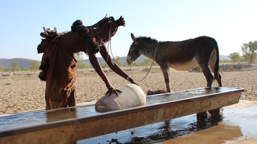 Keriorere and Dendu collect water at Namibia waterpoint.