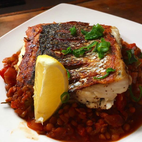Seabass with tomato and lentil stew