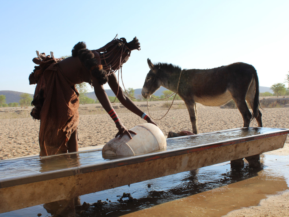 Keriorere and Dendu collect water at Namibia waterpoint