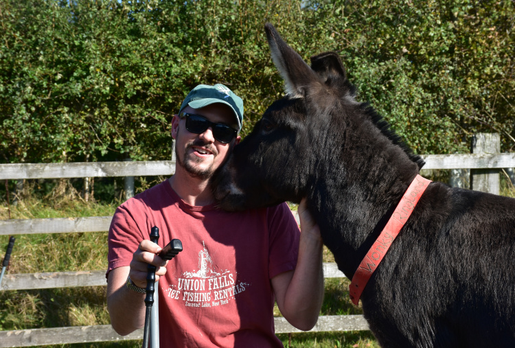 Wildlife and conservation volunteer with donkey