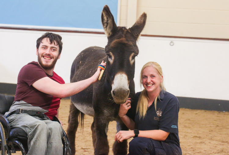 Francis and Harbin with a donkey sanctuary staff member
