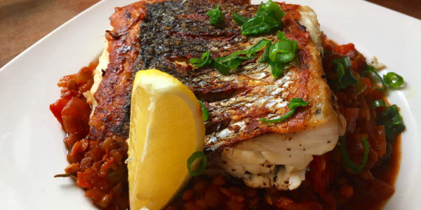 Seabass with tomato and lentil stew