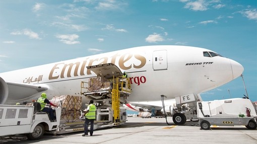 A emirates aeroplane being loaded with cargo