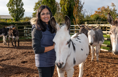 New Trustee Madhu Murali stood with a white donkey