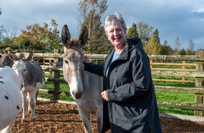 New Trustee Vivienne Hole stood with a grey donkey